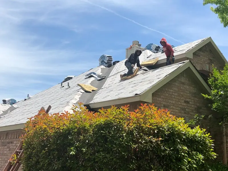 Dimensional Pro Construction crew replacing a roof in North Texas
